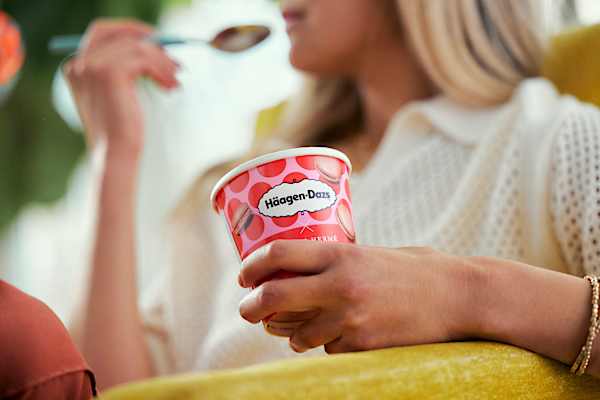 Woman eating pint of Haagen-Dazs ice cream